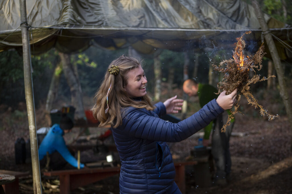 Lady learning to light a fire 