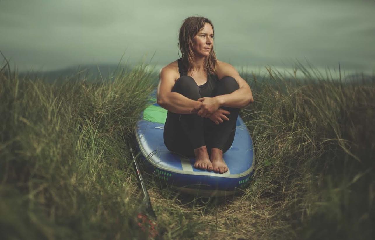 Women sat on paddle board
