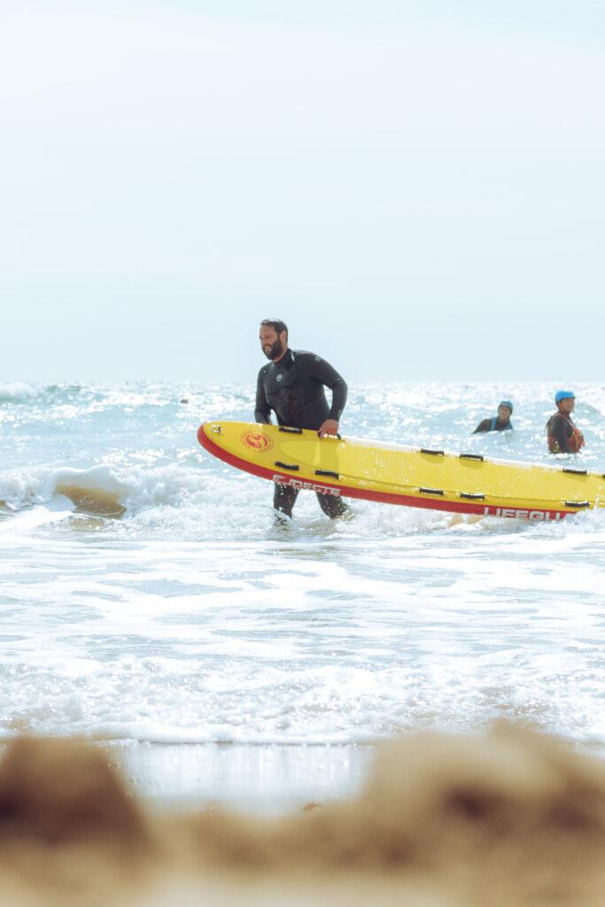 man in the sea with lifeguard vessle