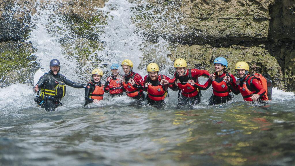 Outdoor Instructors in a line coasteering